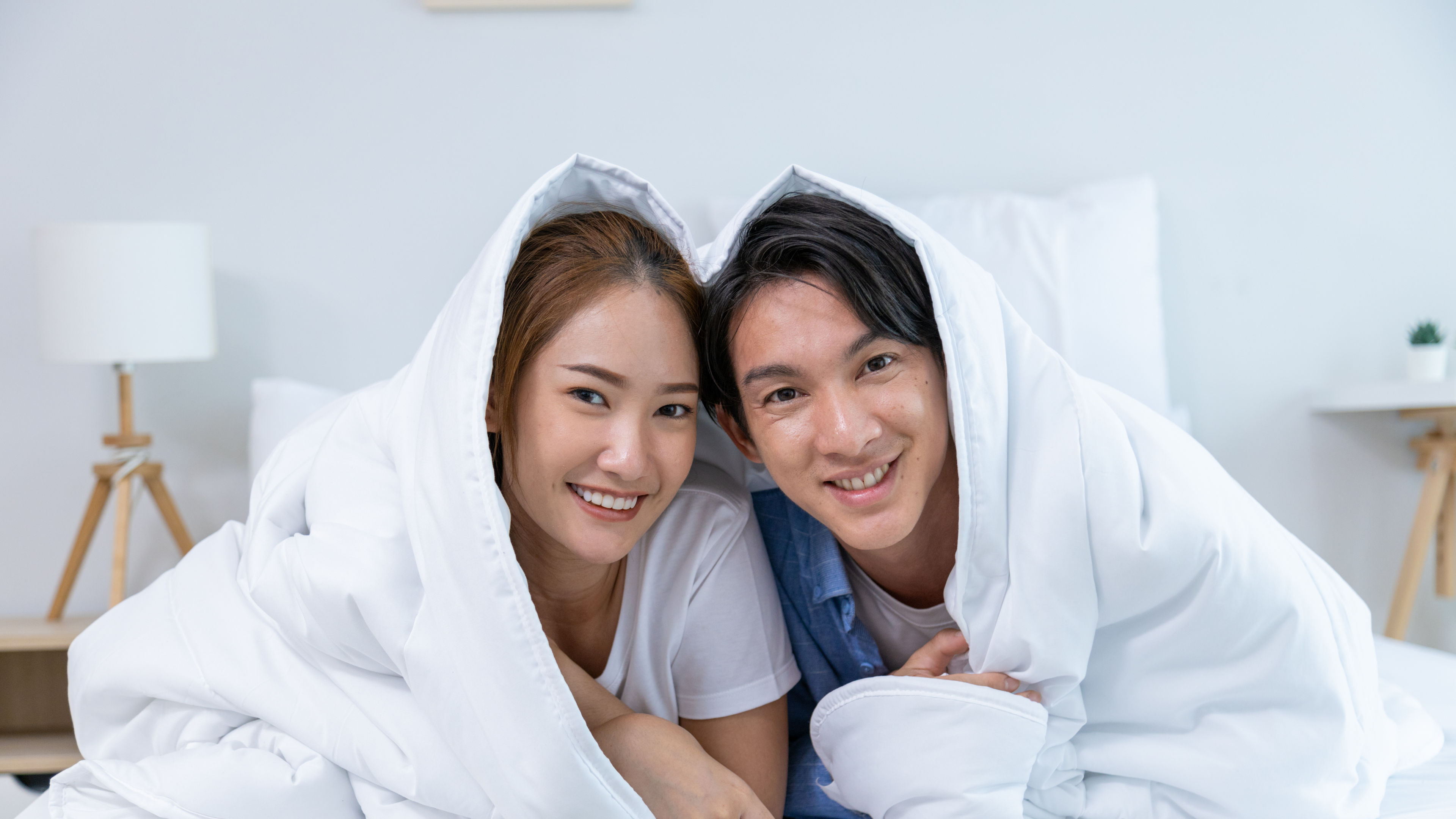 Couple playing in bed